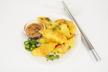 Crispy dumplings and sauces on white background