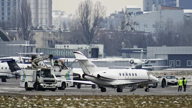 Slow video is preparing a private small plane for departure at the airport sprinkled with antifreeze.