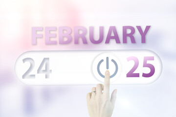 February 25th. Day 25 of month, Calendar date.Hand finger switches pointing calendar date on sunlight office background. Winter month, day of the year concept.