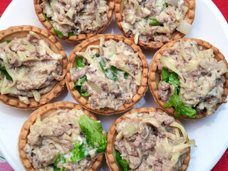Tartlets with cod liver and herbs