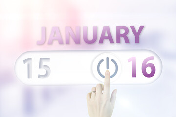 January 16th. Day 16 of month, Calendar date.Hand finger switches pointing calendar date on sunlight office background. Winter month, day of the year concept.