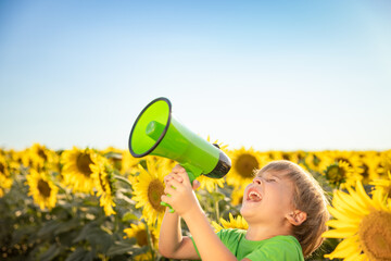 Child in spring sunflower field