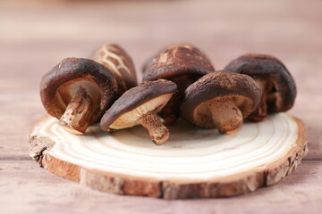 raw champignon mushroom on a chopping board on table 