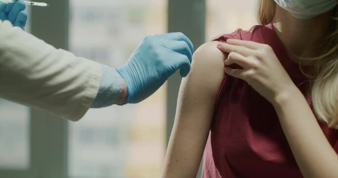 Doctor giving Covid-19 or flu antivirus vaccine. Vaccination concept.