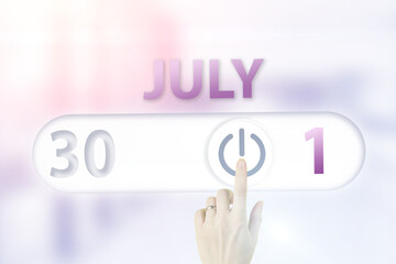 July 1st . Day 1 of month, Calendar date.Hand finger switches pointing calendar date on sunlight office background. Summer month, day of the year concept.