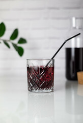 cold cherry drink in a glass beaker in grey background