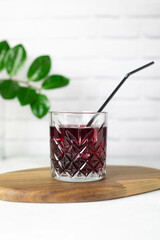 cold cherry drink in a glass on the wooden
