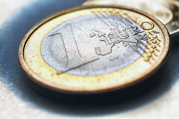 Euro coins. The focus is on the inscription with the name of the Euro Zone currency on the 1 euro...