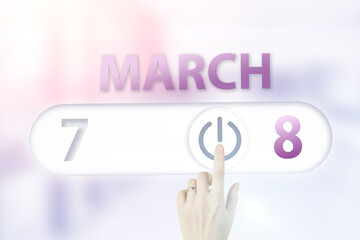 March 8th. Day 8 of month, Calendar date.Hand finger switches pointing calendar date on sunlight office background. Spring month, day of the year concept.