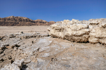 Ecological catastrophe of the disappearing Dead Sea. Erosion and salt formations on the surface of...