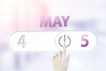 May 5th. Day 5 of month, Calendar date.Hand finger switches pointing calendar date on sunlight office background. Spring month, day of the year concept.