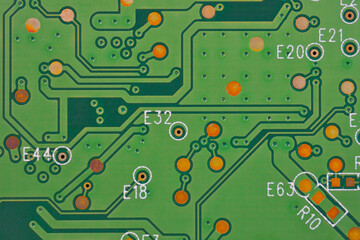 Green printed circuit board PCB hard drive. Fragment of printed wiring board PWB closeup. Conductive patterns. Background or wallpaper about computer hardware and equipment. Strong macro