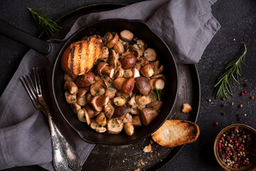 Porcini mushrooms cooked in a frying pan with grilled bread