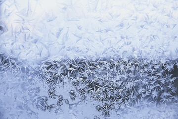 frost patterns on window glass, abstract background winter rime snow