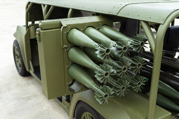 Military vehicle with ammunition. Mortar shells are located on artillery combat equipment. Close-up - obrazy, fototapety, plakaty