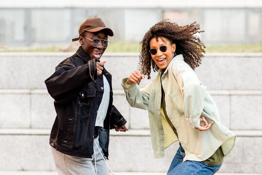 Active young women dancing, african american female having fun, hip hop style music and dance, street lifestyle, generation z people