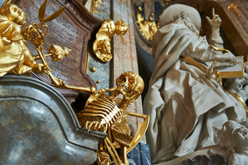 Golden skeleton as a symbol of the passage of time and death inside the Asamkirche church