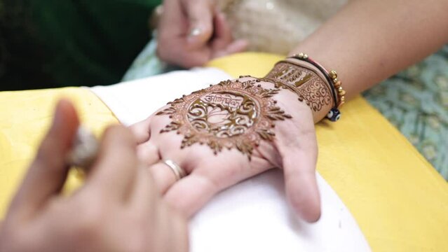 A Shot of a person applying mehendi at an Indian Wedding Venue in New Delhi,India
