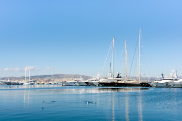 Fototapeta na wymiar Beautiful yachts on the pier against the blue sky, Athens embankment