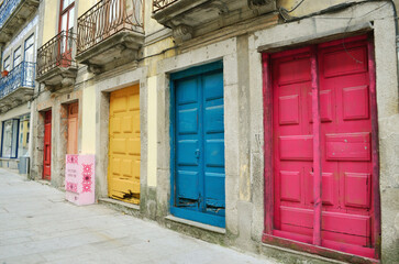 Facade of a building with colorful wooden doors in the city centre of Porto, in Portugal