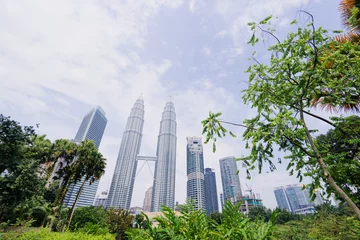 Fotobehang Kuala Lumpur, Malaysia - The Petronas Twin Towers against blue sky, The world's tallest Twin Towers. © luengo_ua