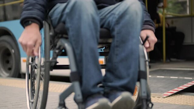 Person with a physical disability leaves public transport with an accessible ramp