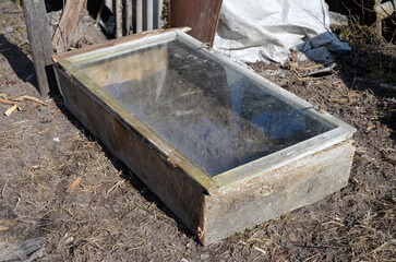 Insulated bed, greenhouse of old window frames.
