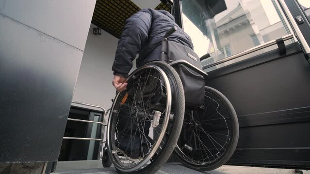 Special elevator for the person with a physical disabilities. A man in a wheelchair uses a special elevator