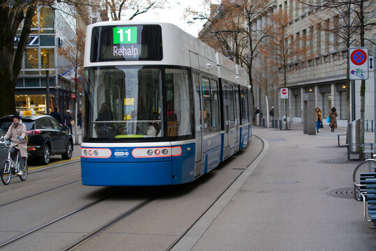 Famous Bahnhofstrasse at City of Z&uuml;rich on a cloudy winter day with tram number 11 and passengers. Photo taken February 3rd, 2022, Zurich, Switzerland.