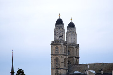 Fototapeta premium Protestant church Great Minster at the medieval old town of Zürich on a cloudy winter day. Photo taken February 3rd, 2022, Zurich, Switzerland.