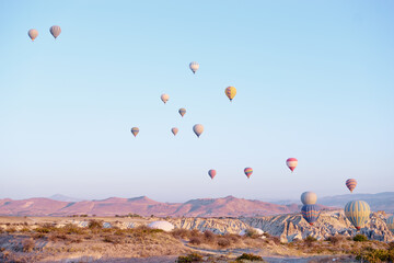 Travel and tourism by Turkey. Famous sightseeing Cappadocia, Anatolia. Beautiful landscape with mountains, caves and baloons in the sky.
