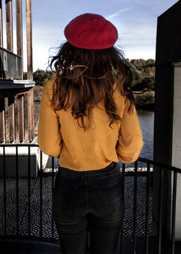 Young woman seen from behing with red beret