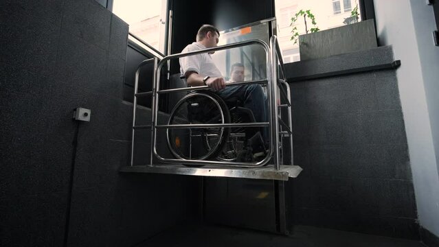 Special elevator for the person with a physical disabilities. A man in a wheelchair uses a special elevator