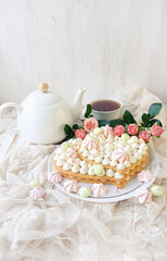 beautiful sponge cake with flowers, teapot and cup on table. Valentine's day or Mother's Day, birthday festive concept. delicious sweet treat cake. romantic party