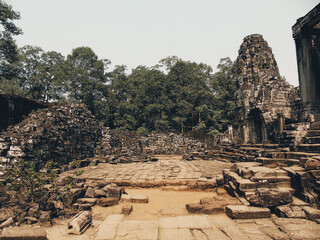 Ruins of an ancient stone temple lost in the Cambodian jungle - Bayon of Angkor temples