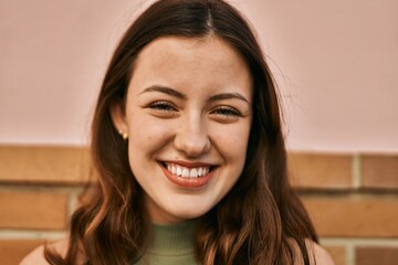 Young caucasian girl smiling happy standing at the city.