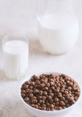 Breakfast: chocolate balls, fresh cows milk, selective focus
