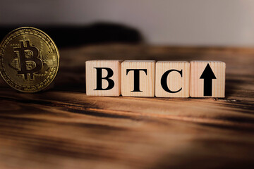  Wooden cubes with the inscription: "BTC". Business concept. Bitcoin growth.