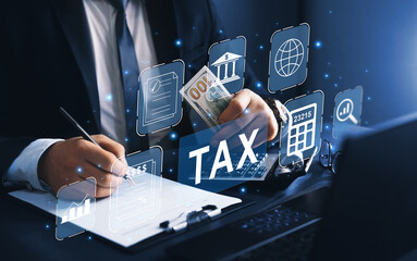 Business person using a laptop to complete income tax return form online.Calculation tax return...