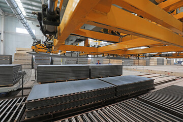 workers operate the distributor on the calcium silicate board production line, North China