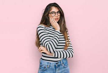 Young beautiful teen girl wearing casual clothes and glasses thinking looking tired and bored with...