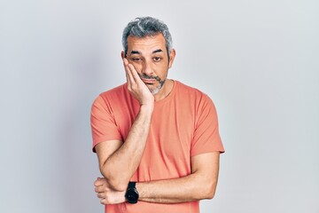 Fototapeta premium Handsome middle age man with grey hair wearing casual t shirt thinking looking tired and bored with depression problems with crossed arms.