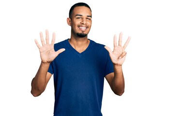 Young african american man wearing casual t shirt showing and pointing up with fingers number nine...