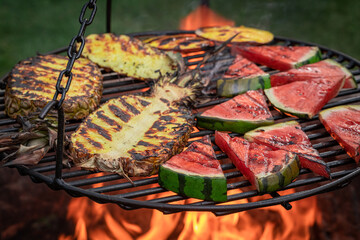 Hot roasted watermelon and pineapple in the summer garden.