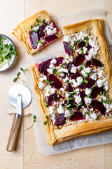 Beetroot and feta filo pizza. Beet Tart with feta, caramelized onion, pine nuts, sunflower micro greens and phyllo dough. Savoury vegetable vegetarian baking.