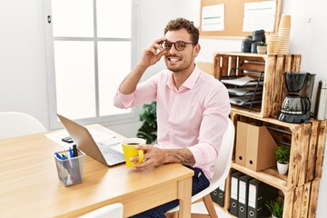 Young hispanic man smiling confident working at office