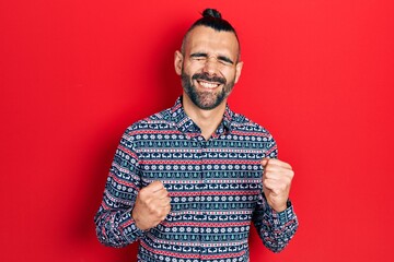 Young hispanic man wearing casual clothes celebrating surprised and amazed for success with arms raised and eyes closed