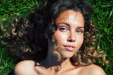 young cute summer girl on green grass outside relaxing smiling, lifestyle people concept