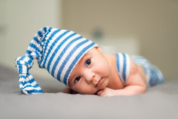 Newborn baby with knitted cap. Baby portrait.