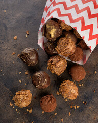 Truffle chocolate candies with assorted wafer crumbs. Sweet homemade dessert on a plate